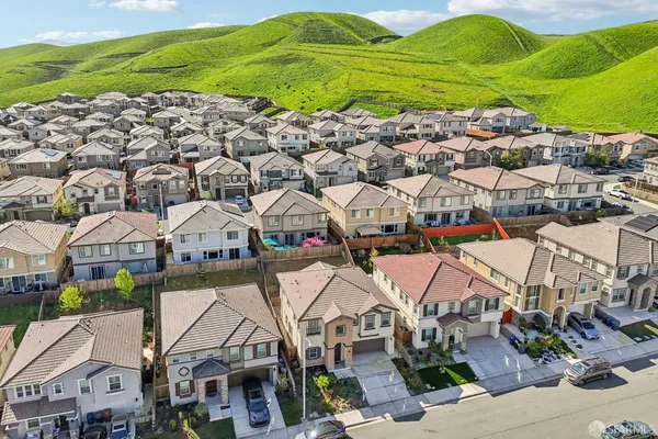 a view of a house with a wooden deck