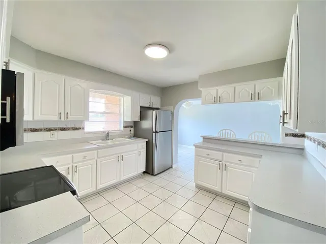 a kitchen with granite countertop cabinets and white appliances