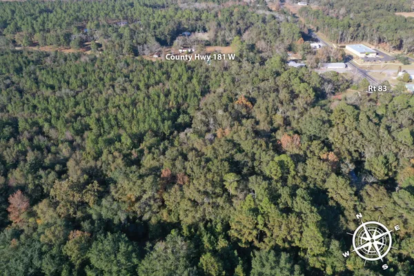 an aerial view of residential house with yard and outdoor seating