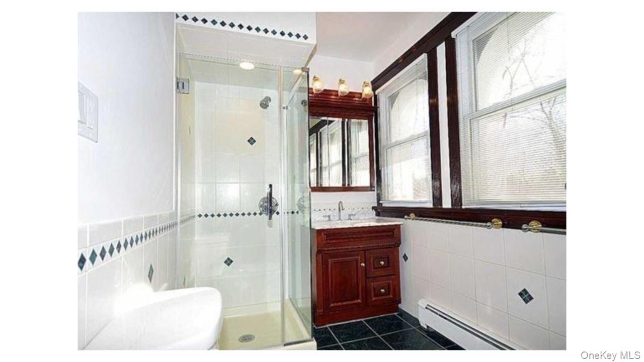 2 Arleigh Road Great Neck, NY 11021 - Photo 19 of 22 Glass-enclosed shower with white tiled walls