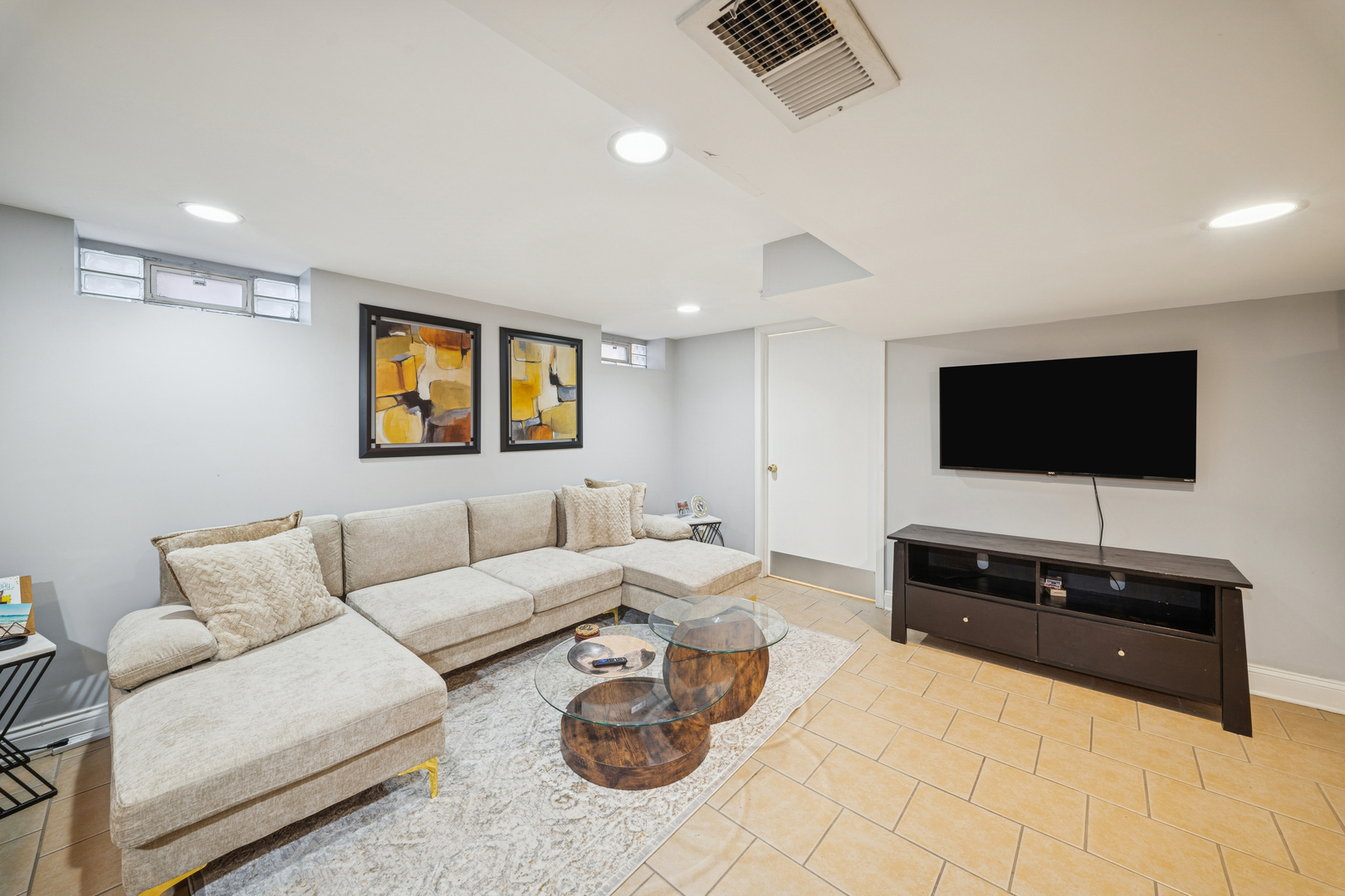 8435 South State Street Chicago, IL 60619 - Photo 11 of 16 a living room with furniture and a flat screen tv