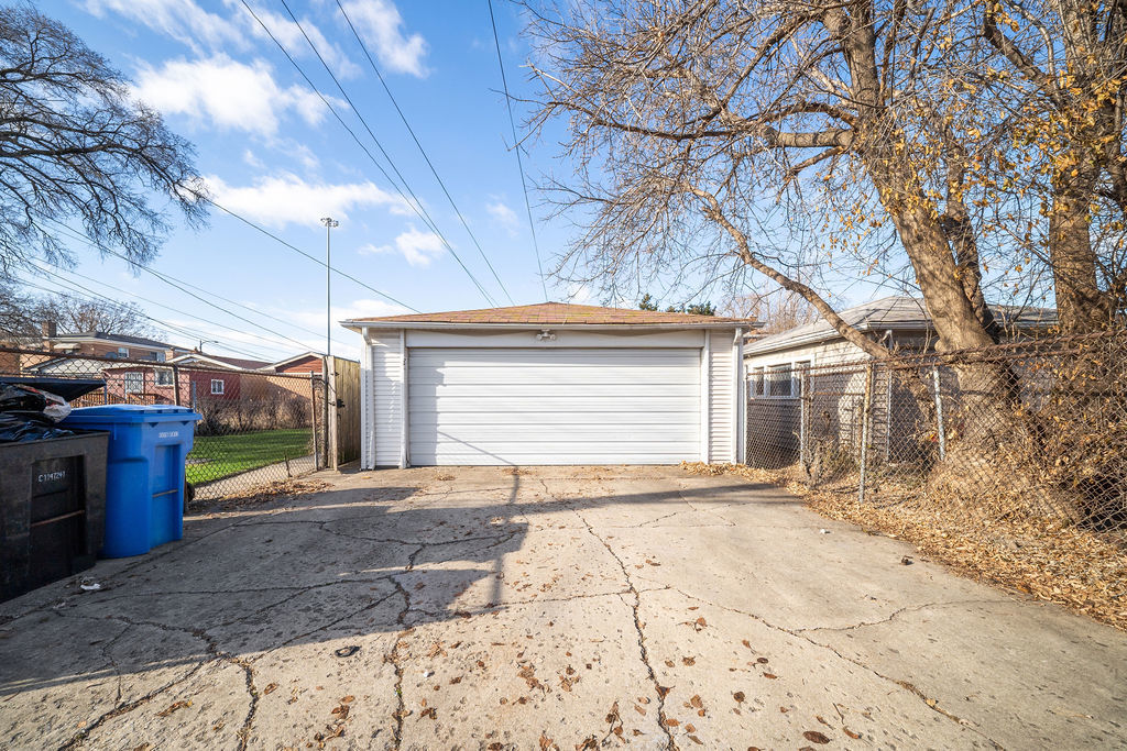 8435 South State Street Chicago, IL 60619 - Photo 16 of 16 a view of a house with a yard and garage