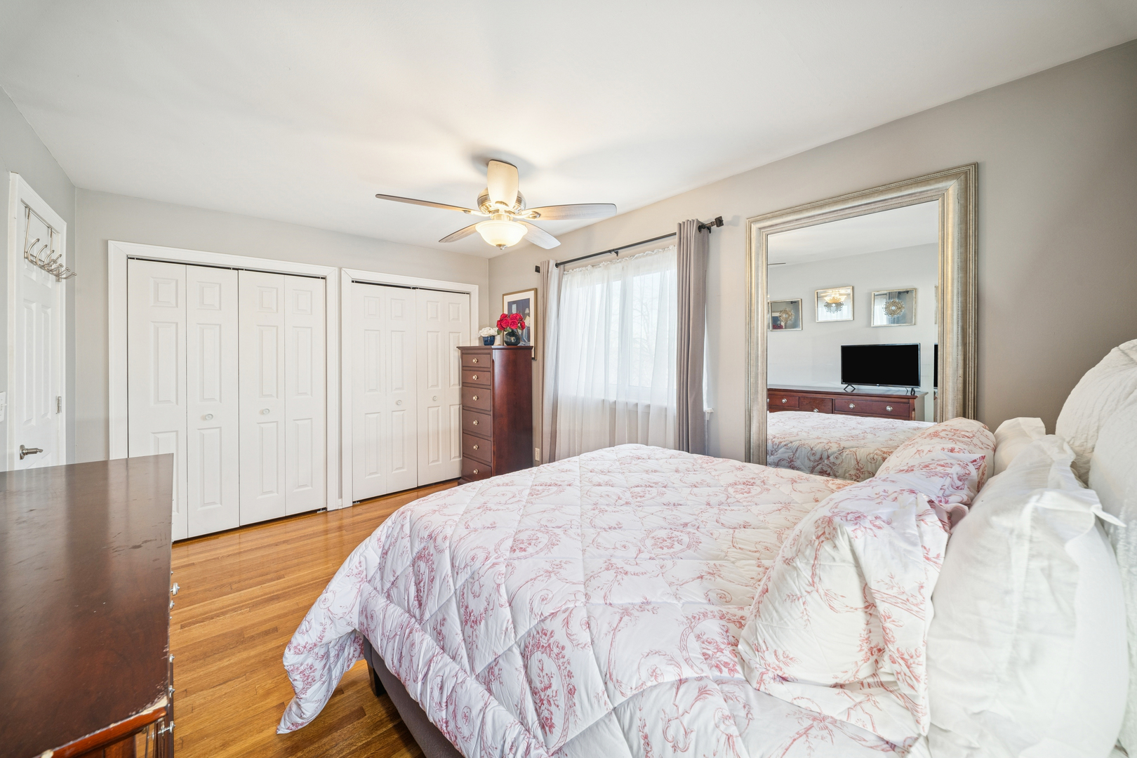 8435 South State Street Chicago, IL 60619 - Photo 8 of 16 a bedroom with a large bed and a chandelier