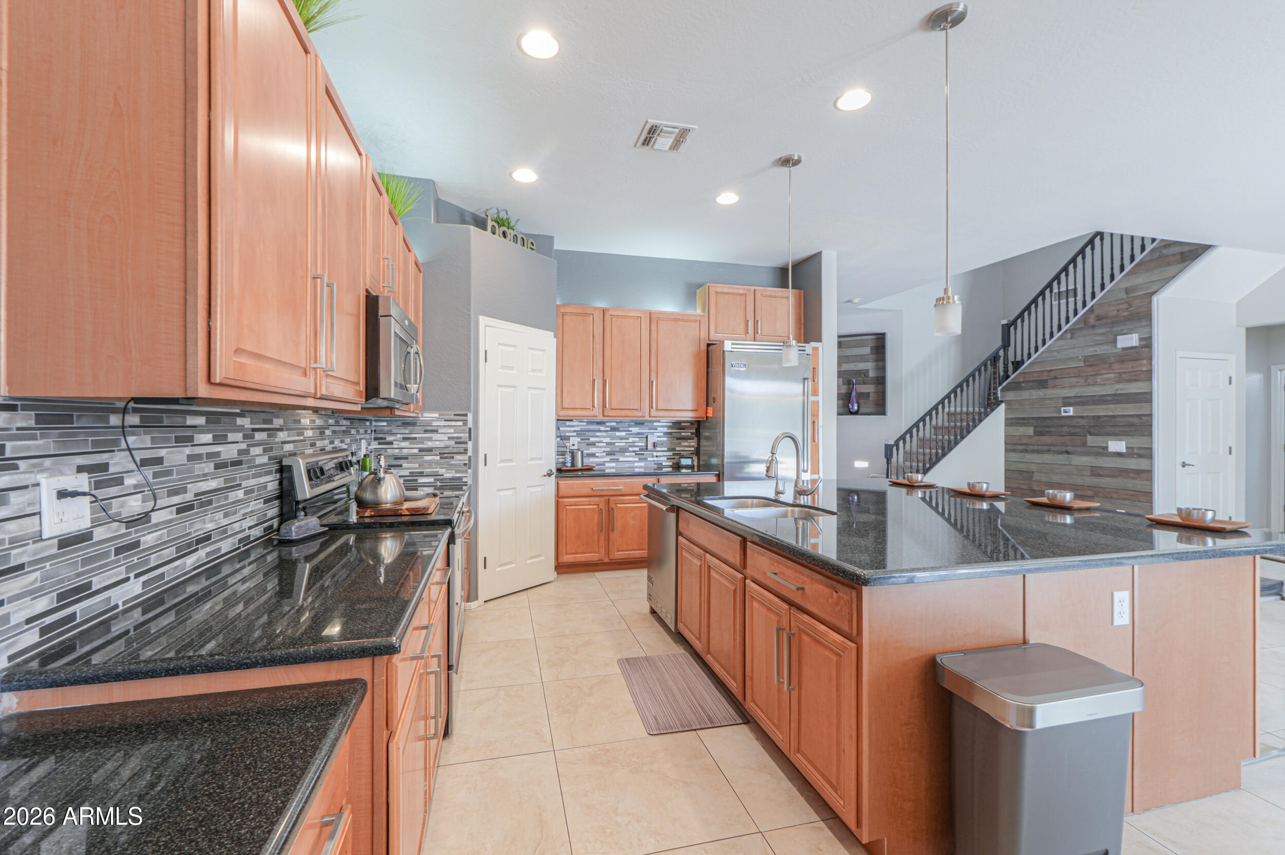 45247 West Jack Rabbit Trail Maricopa, AZ 85139 - Photo 17 of 75 a kitchen with stainless steel appliances granite countertop a stove a sink and a refrigerator