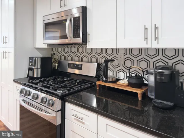 a stove top oven sitting inside of a kitchen