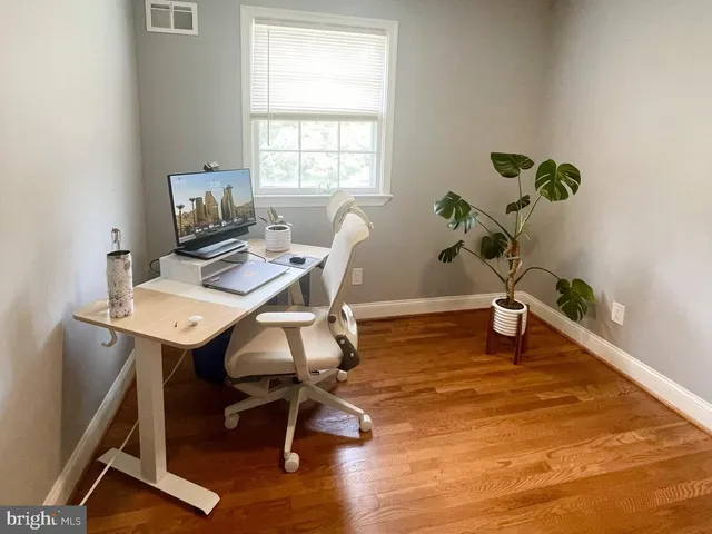 a workspace with furniture window and wooden floor