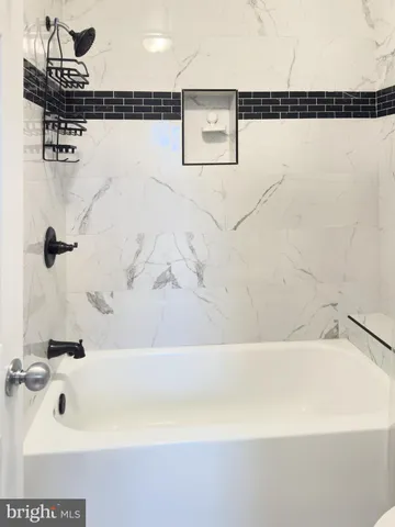 a bathroom with a shower and a bath tub