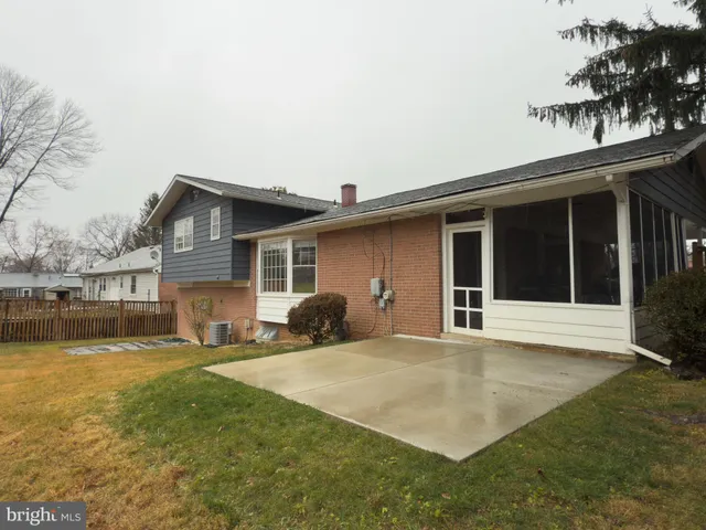 a view of a house with a yard and sitting area