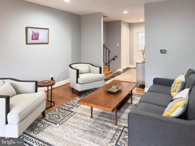 a living room with furniture and a rug