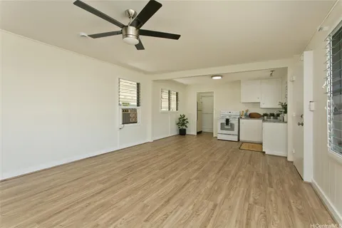 a view of a livingroom with a hardwood floor and a ceiling fan