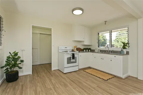 a kitchen with wooden floors and white appliances