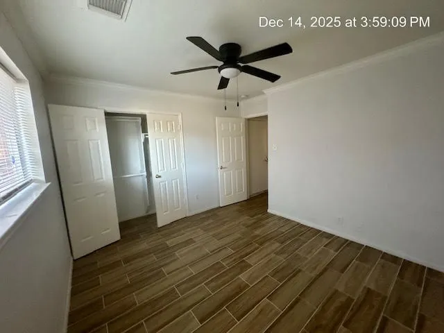 a view of empty room with wooden floor