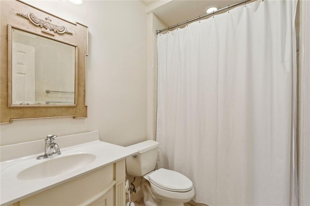 3005 Ranch Road Southeast Atlanta, GA 30339 - Photo 51 of 57 a bathroom with a sink a toilet and shower curtain