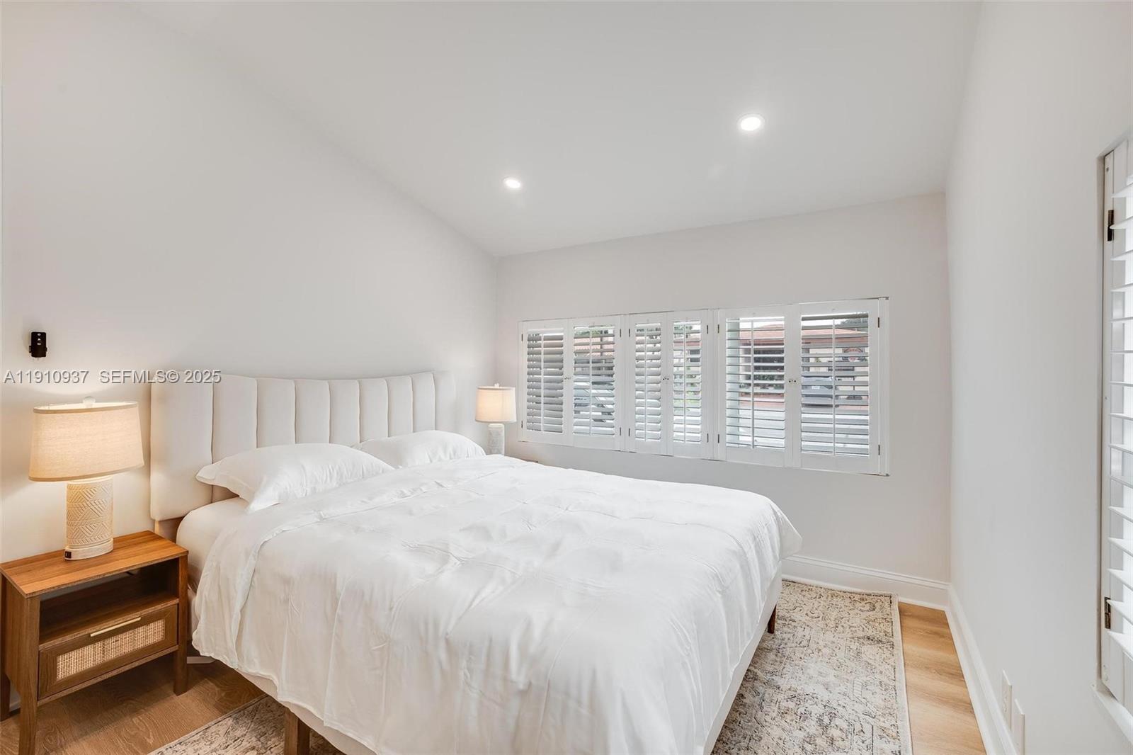 2969 Southwest 20th Street Miami, FL 33145 - Photo 11 of 28 a large bed sitting in a bedroom next to a lamp