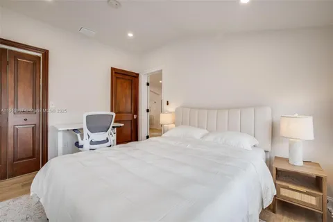 a bedroom with a bed and a lamp