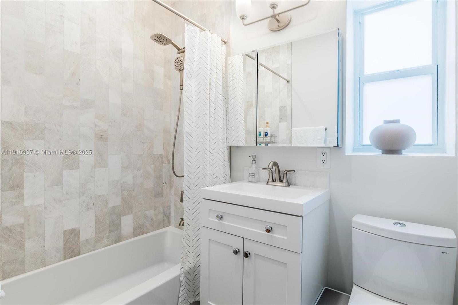 2969 Southwest 20th Street Miami, FL 33145 - Photo 17 of 28 a bathroom with a sink a toilet and shower