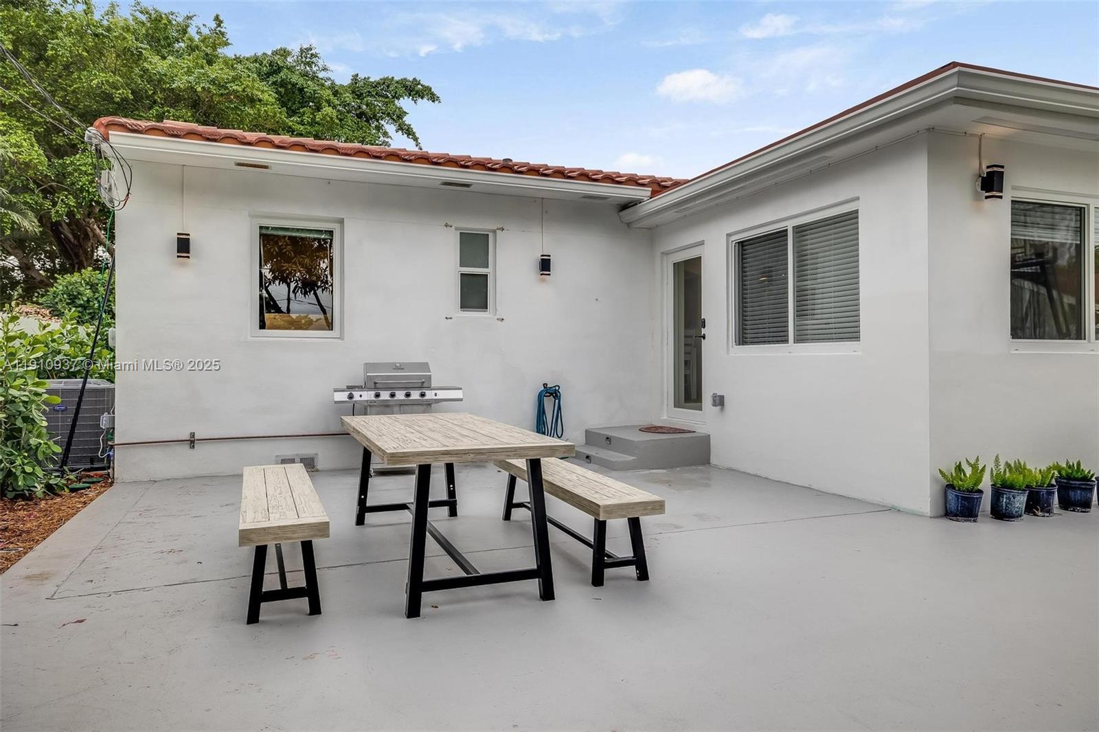 2969 Southwest 20th Street Miami, FL 33145 - Photo 23 of 28 a backyard of a house with table and chairs