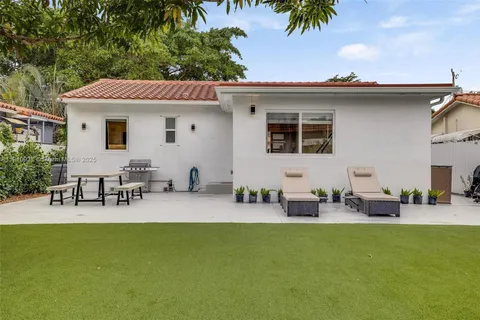 a view of a patio with table and chairs potted plants with wooden fence
