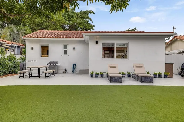 a view of a patio with table and chairs potted plants with wooden fence