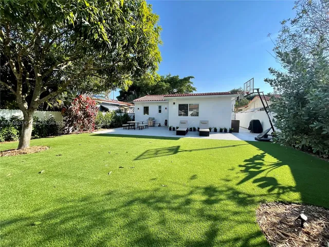 a swimming pool view with a seating space and a garden view