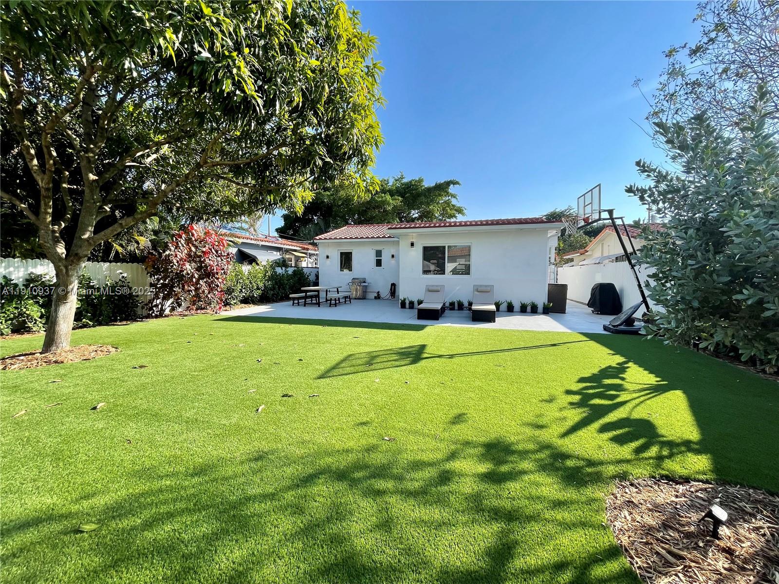 2969 Southwest 20th Street Miami, FL 33145 - Photo 27 of 28 a swimming pool view with a seating space and a garden view