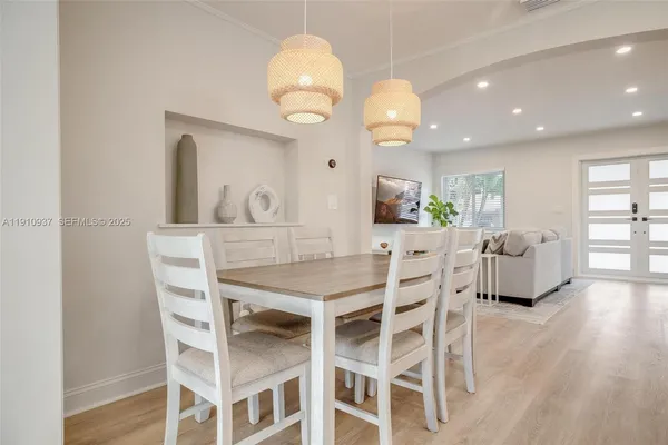 a view of a dining room with furniture and wooden floor