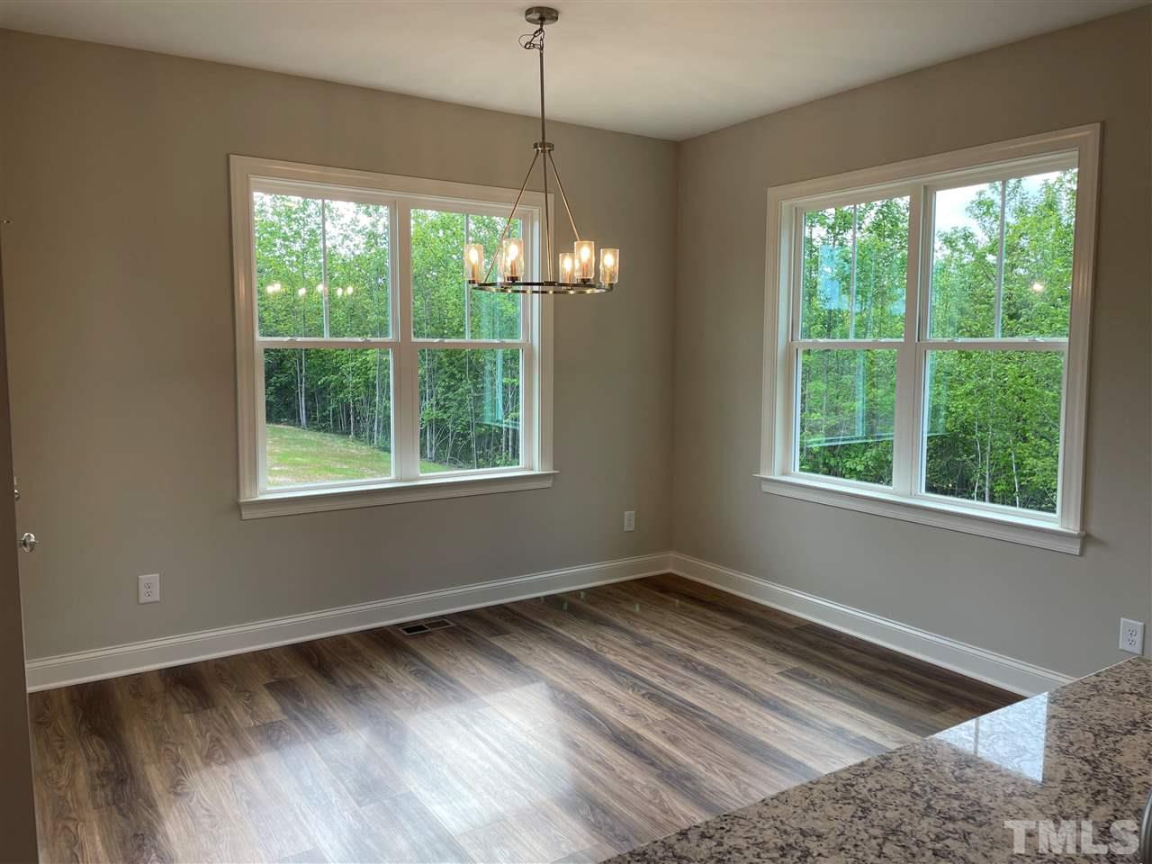 1820 Bryantown Road Spring Hope, NC 27882 - Photo 11 of 23 a view of an empty room with wooden floor and a window