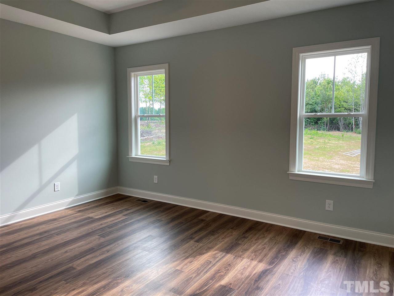1820 Bryantown Road Spring Hope, NC 27882 - Photo 12 of 23 a view of an empty room with wooden floor and a window
