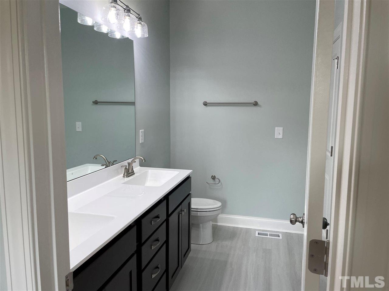1820 Bryantown Road Spring Hope, NC 27882 - Photo 14 of 23 a bathroom with a sink toilet and shower
