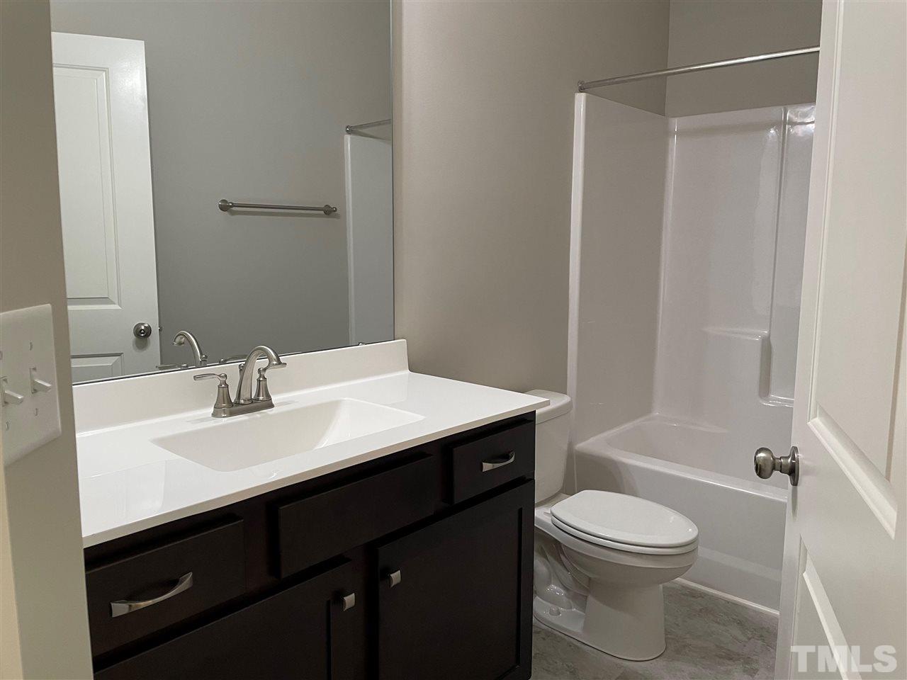 1820 Bryantown Road Spring Hope, NC 27882 - Photo 18 of 23 a bathroom with a sink a toilet and shower