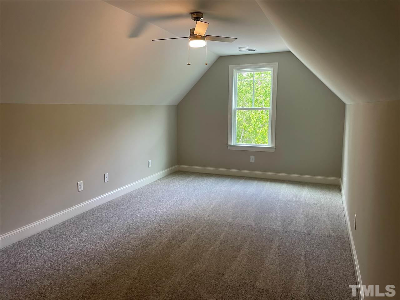 1820 Bryantown Road Spring Hope, NC 27882 - Photo 19 of 23 an empty room with a window and a ceiling fan