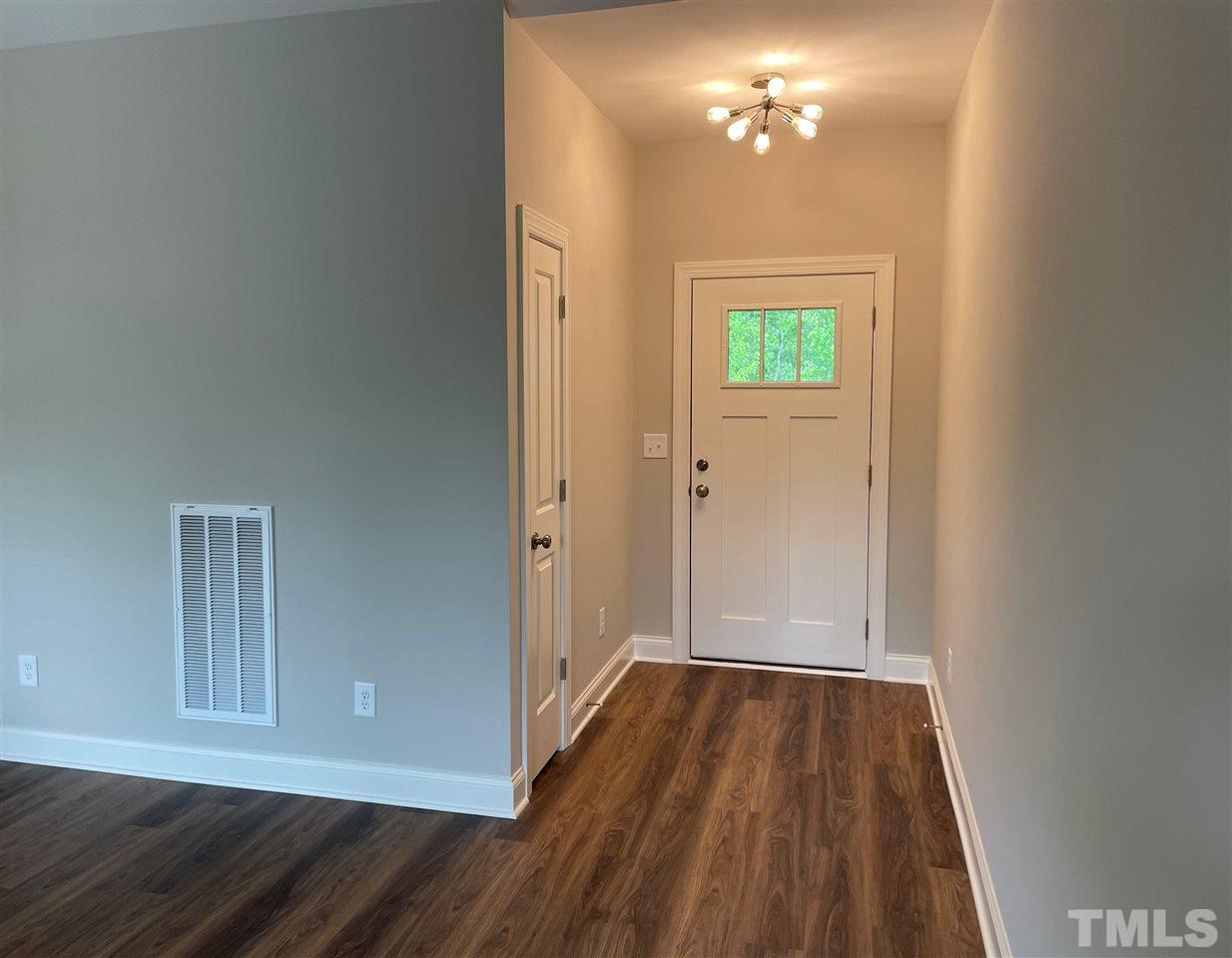 1820 Bryantown Road Spring Hope, NC 27882 - Photo 4 of 23 a view of empty room with wooden floor
