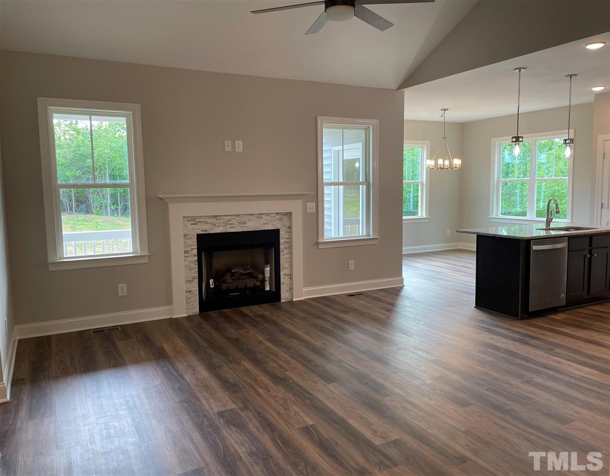 1820 Bryantown Road Spring Hope, NC 27882 - Photo 5 of 23 wooden floor fireplace and windows in an empty room