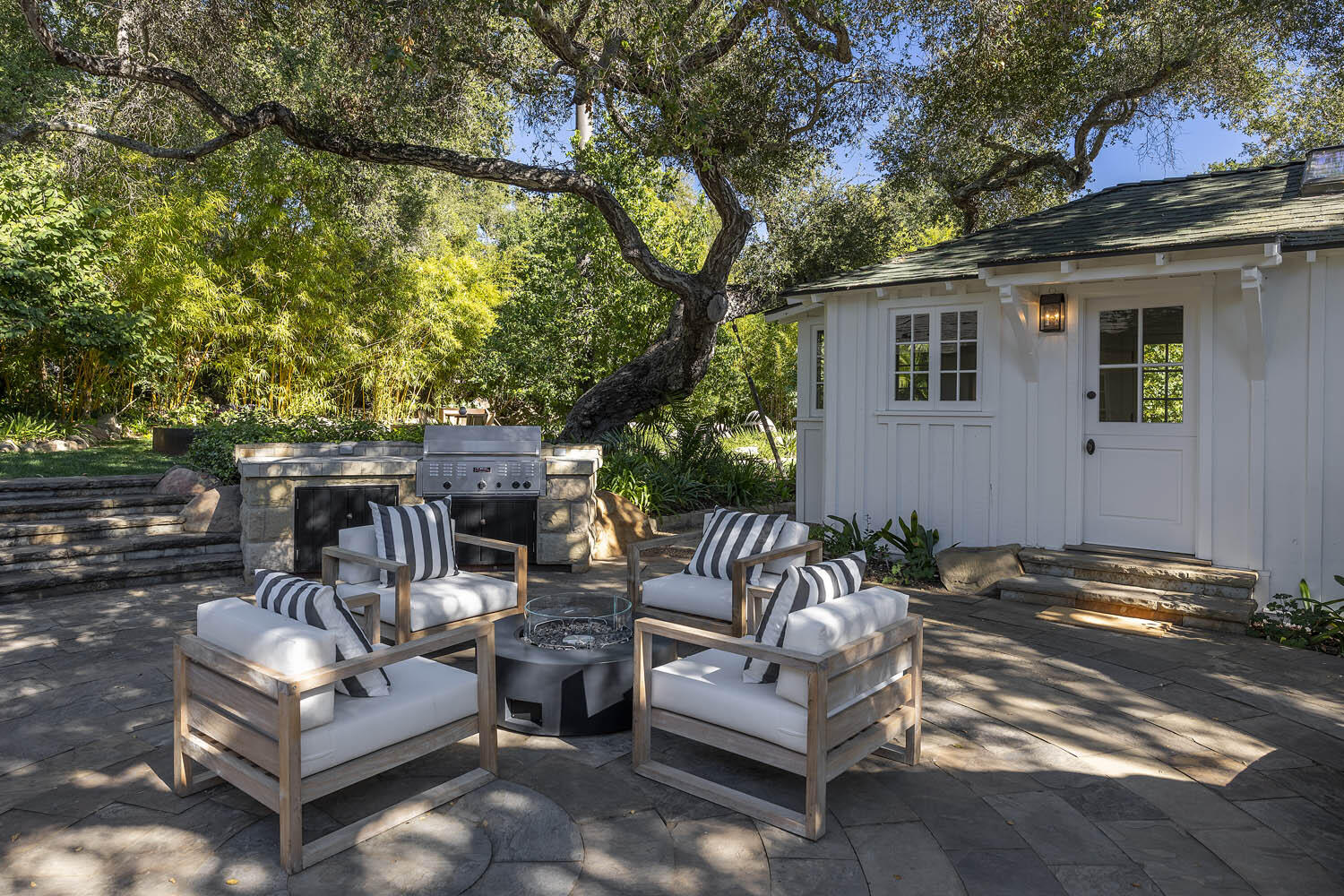 830 Riven Rock Road Montecito, CA 93108 - Photo 23 of 36 a view of a patio with couches chairs and a fire pit
