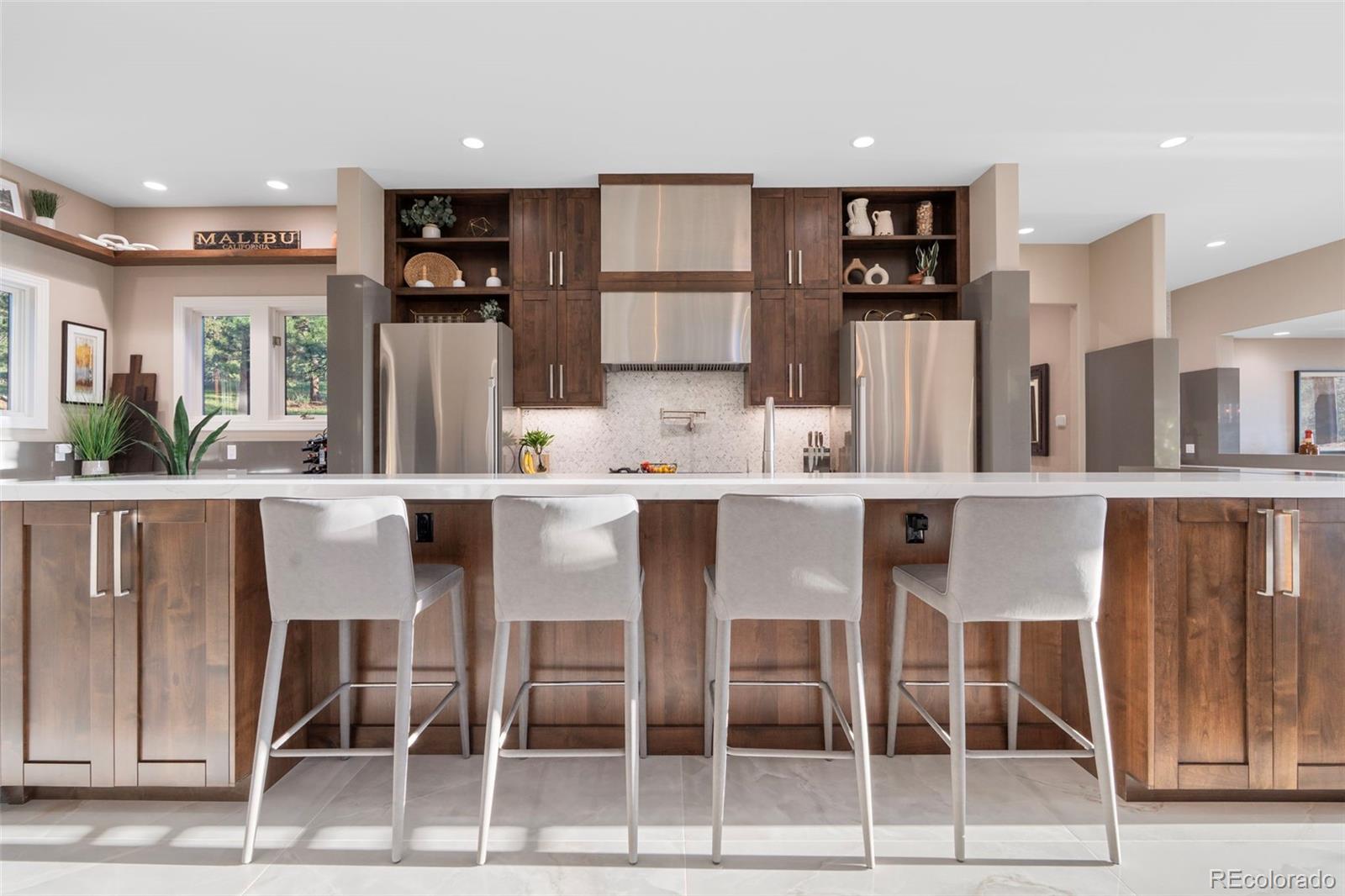 730 Genesee Mountain Road Golden, CO 80401 - Photo 15 of 50 a dining area with stainless steel appliances kitchen island granite countertop a dining table chairs and view kitchen