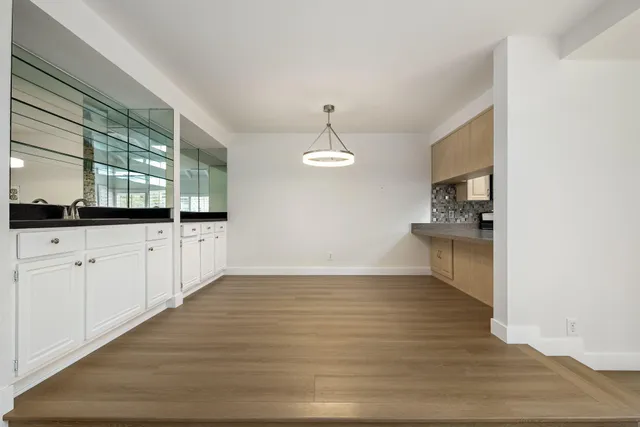 a view of a kitchen with granite countertop cabinets and wooden floor