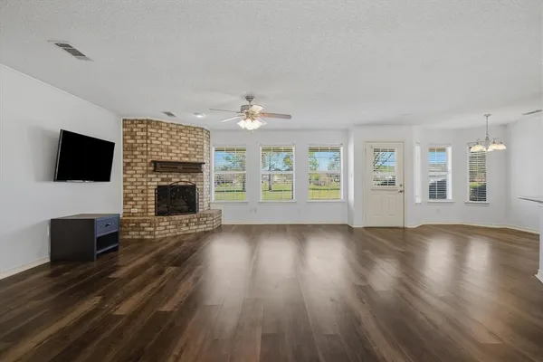 a kitchen with a stove a refrigerator and wooden cabinets