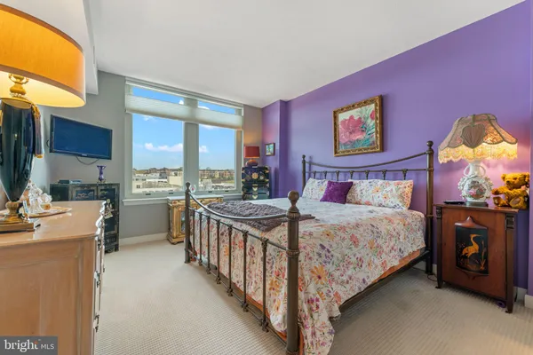 a bedroom with a bed and a view of kitchen