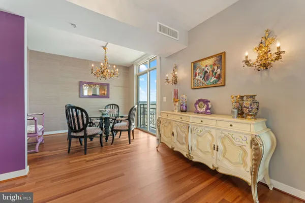 a view of dining room and kitchen with furniture wooden floor and chandelier