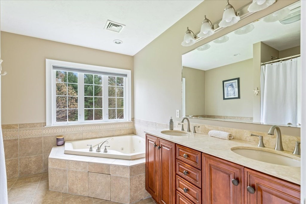 176 Marion Road Middleboro, MA 02346 - Photo 24 of 41 a bathroom with a granite countertop sink and a bathtub