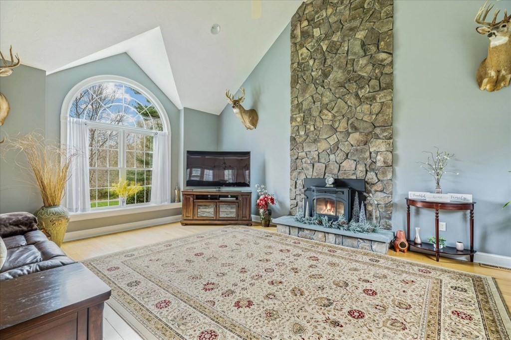 176 Marion Road Middleboro, MA 02346 - Photo 10 of 41 a living room with furniture a window and a fireplace