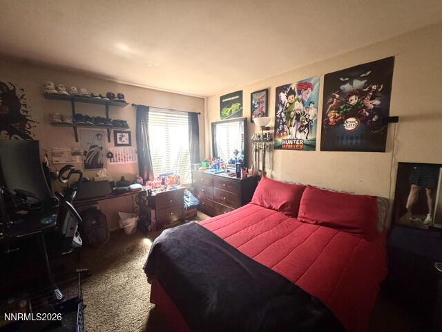 1557 Delucchi Lane, Unit G Reno, NV 89502 - Photo 6 of 8 a bed room with a bed and paintings on the wall