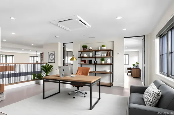 a living room with furniture a rug and a window