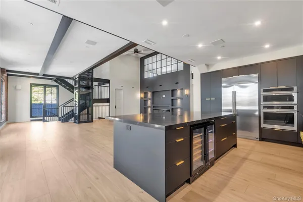 a kitchen with stainless steel appliances granite countertop a stove and a refrigerator