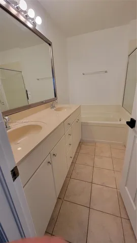 a white bath tub sitting next to a shower