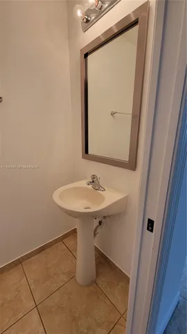 a bathroom with a sink a mirror and a toilet
