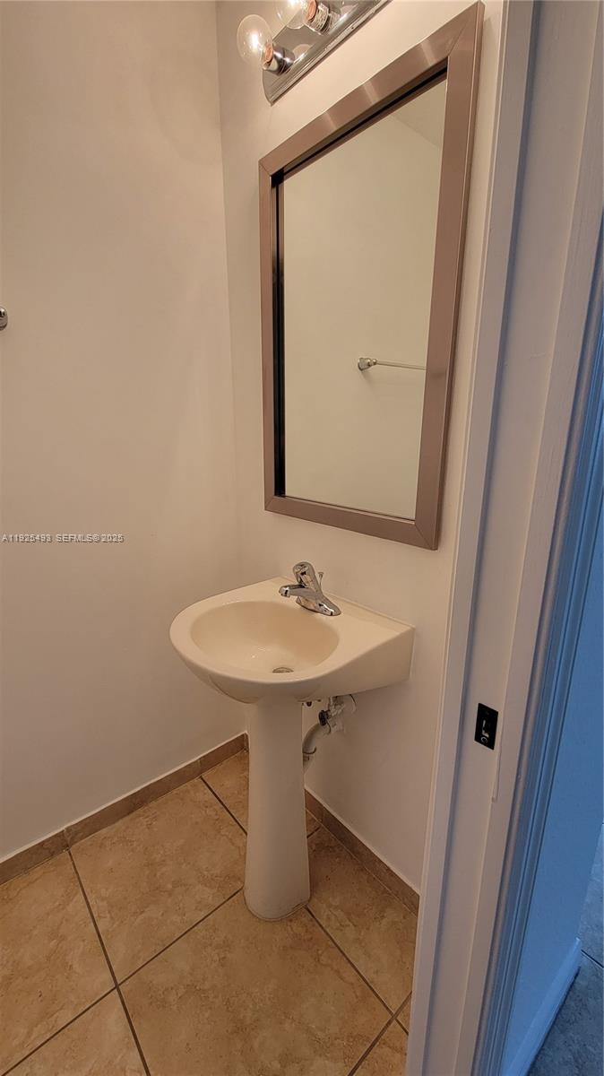 12600 Southwest 50th Court, Unit 437 Miramar, FL 33027 - Photo 10 of 24 a bathroom with a sink a mirror and a toilet