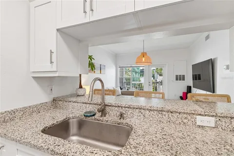 a kitchen with granite countertop a sink and a window