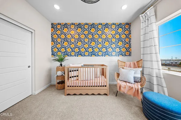 a bedroom with furniture and a book shelf