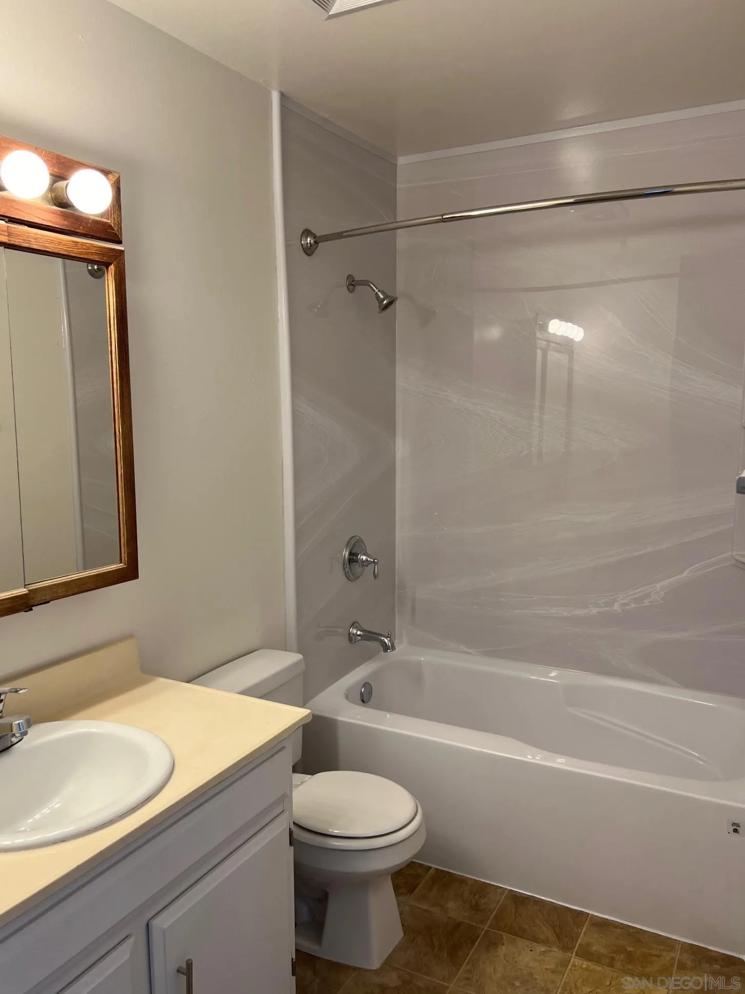 2018 Terracina Circle Spring Valley, CA 91977 - Photo 14 of 24 a bathroom with a sink a toilet and a bathtub